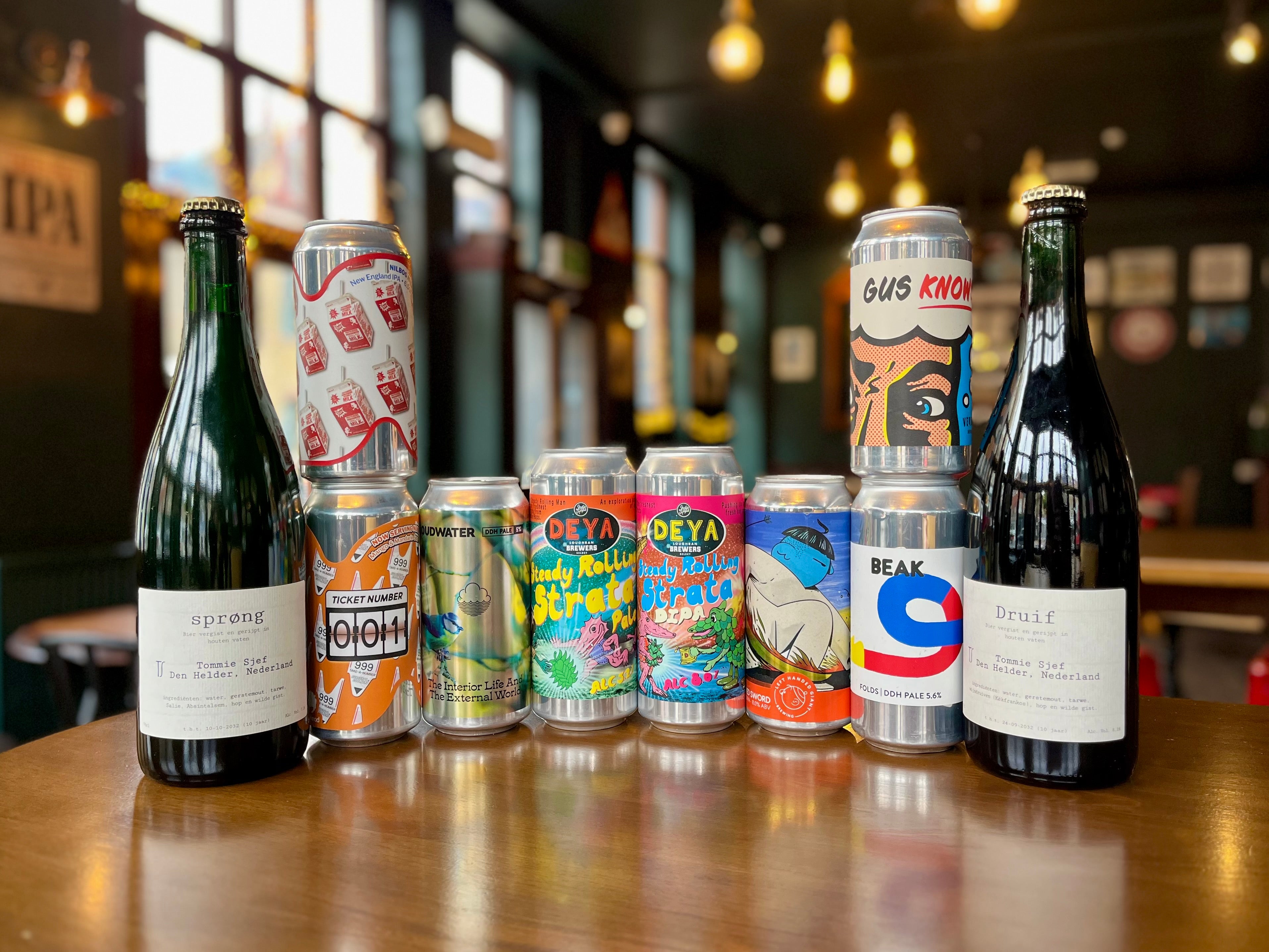 Collection of beer bottles and cans on a table