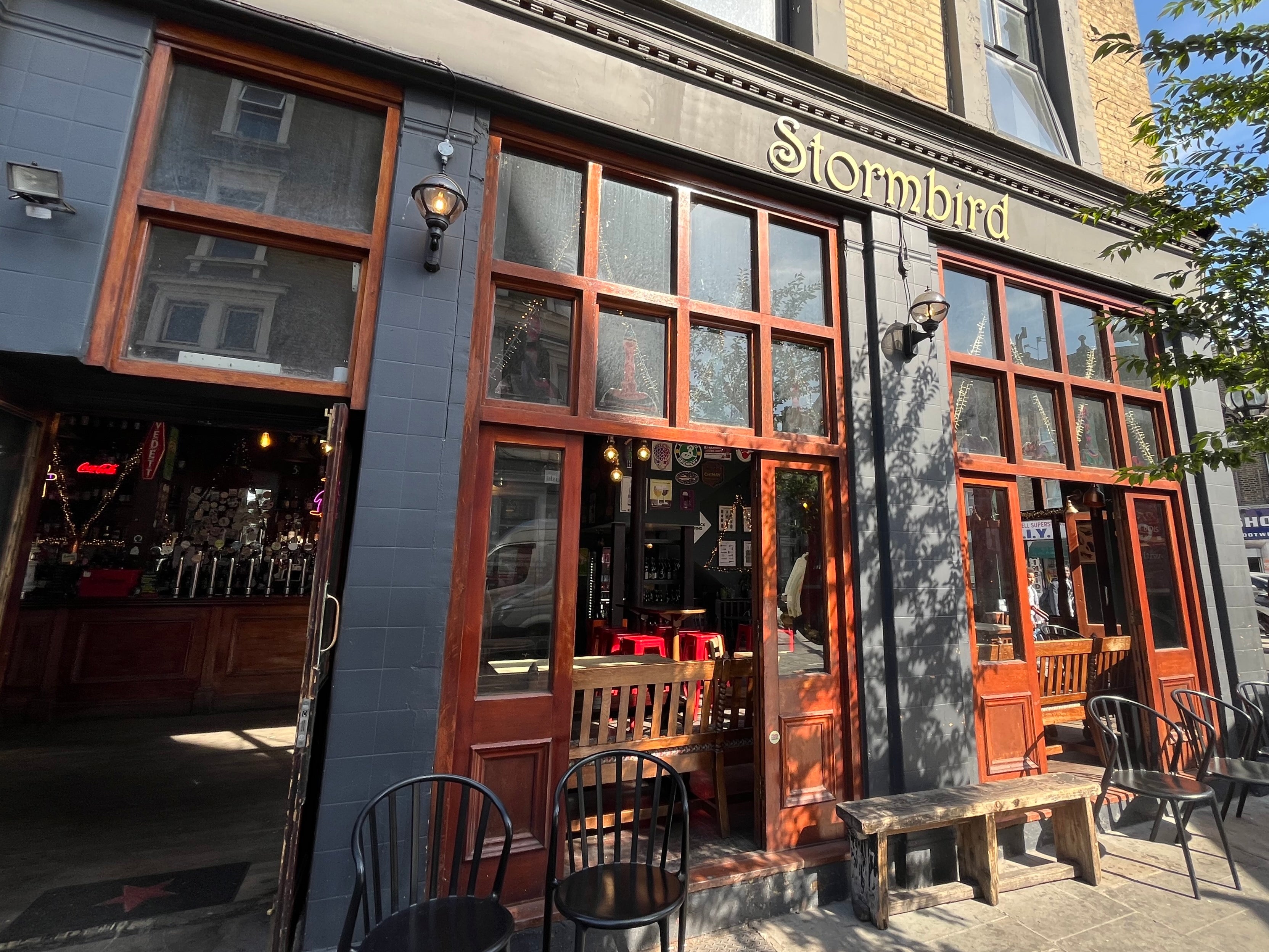 Pub exterior with 'Stormbird' sign and outdoor seating
